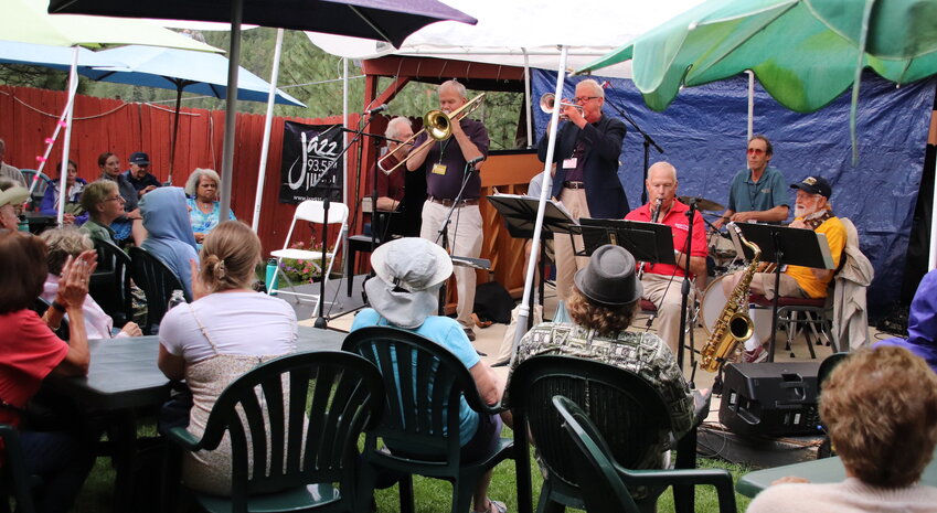 The Queen City Jazz Band with Wende Harston plays through the drizzle on the patio at Evergreen Elks Lodge.